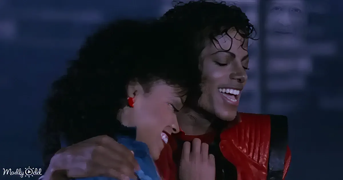 A person in a red outfit is embracing another person with a blue outfit, both smiling.