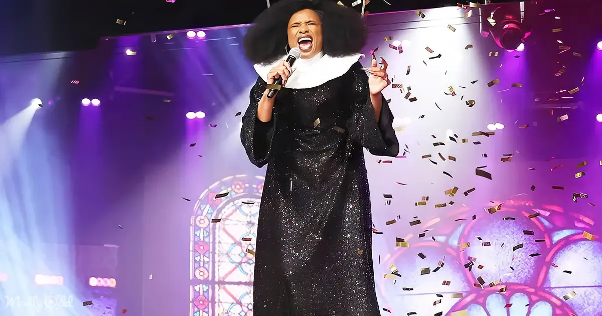 A woman in a black sequined dress sings passionately on stage with confetti falling around her.