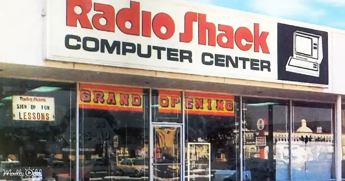 A Radio Shack Computer Center with a "Grand Opening" sign and a vintage computer graphic on the storefront.