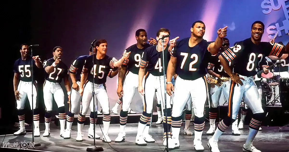 Chicago Bears football players in uniform sing on stage with microphones.