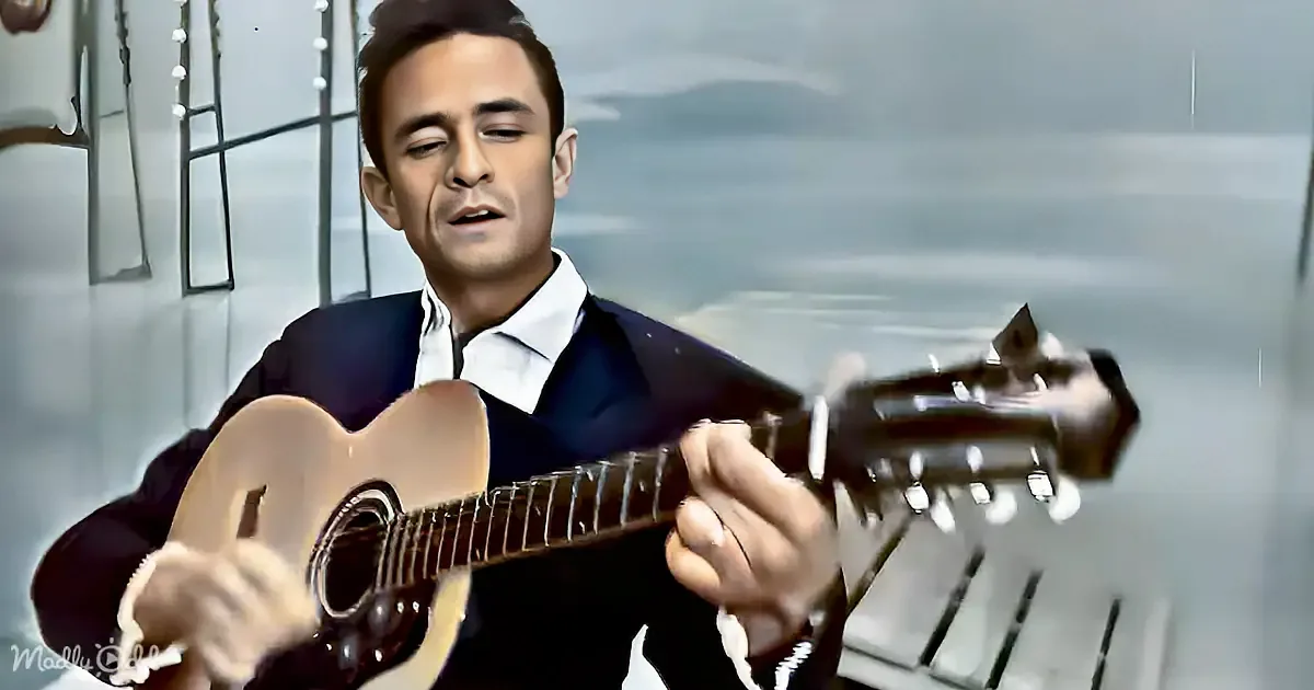 A man in a suit plays a classical guitar with a serene background.