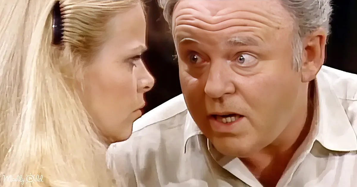A man in a white shirt looks surprised, with a woman in a ponytail beside him.