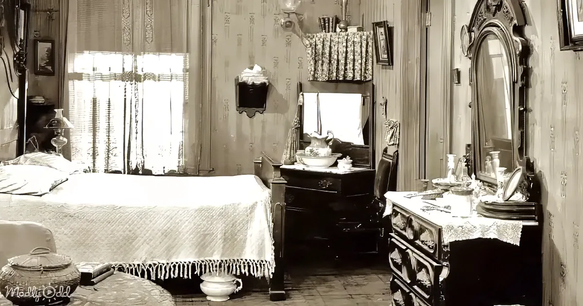 A vintage bedroom with a bed, dresser, mirror, and various antique items, all in sepia tones.