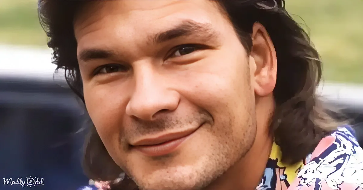 A smiling man with long hair and a patterned shirt, looking directly at the camera.