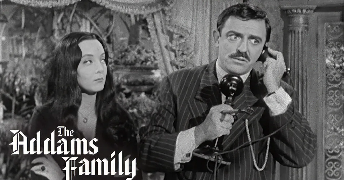 A man in a striped suit holds a telephone, while a woman with long hair looks on, both in a vintage setting.