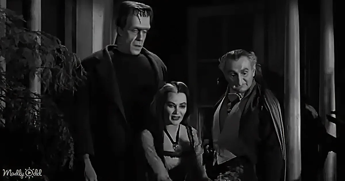 A scene with a tall man in a dark suit, a woman in a dress, and another man in a suit, all standing indoors.