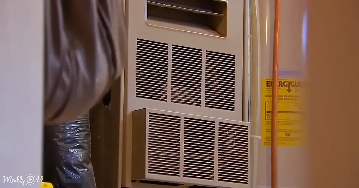 A close-up of a white air conditioning unit with vents and a yellow EnergyGuide label.