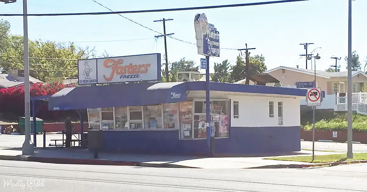 A Foster's Freeze ice cream shop with a blue and white exterior and a sign featuring a cartoon character.