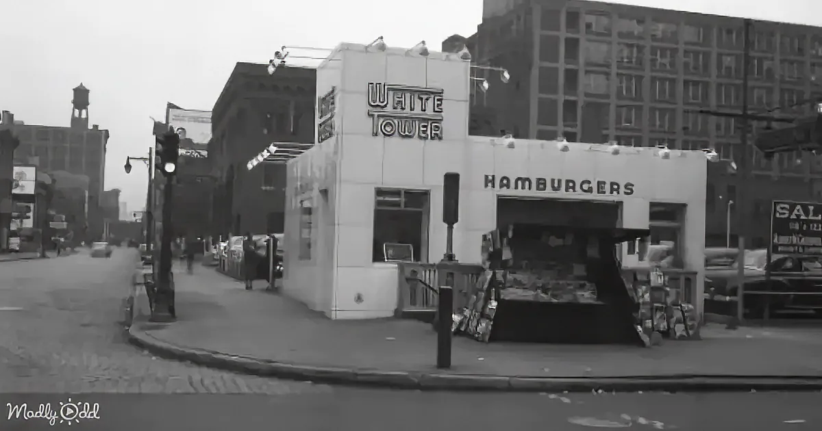 A vintage "White Tower Hamburgers" building stands prominently on a city street corner.