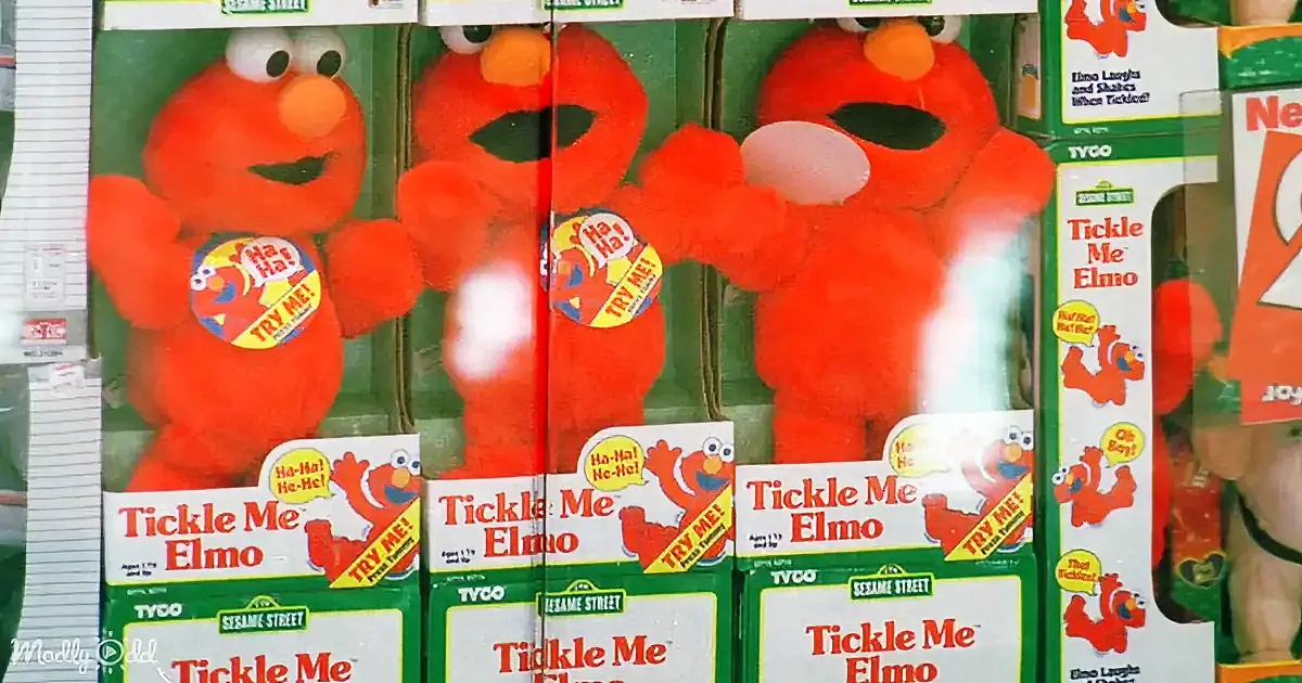 Multiple boxes of "Tickle Me Elmo" toys, featuring Elmo from Sesame Street, with a "TRY ME!" sticker on each box.