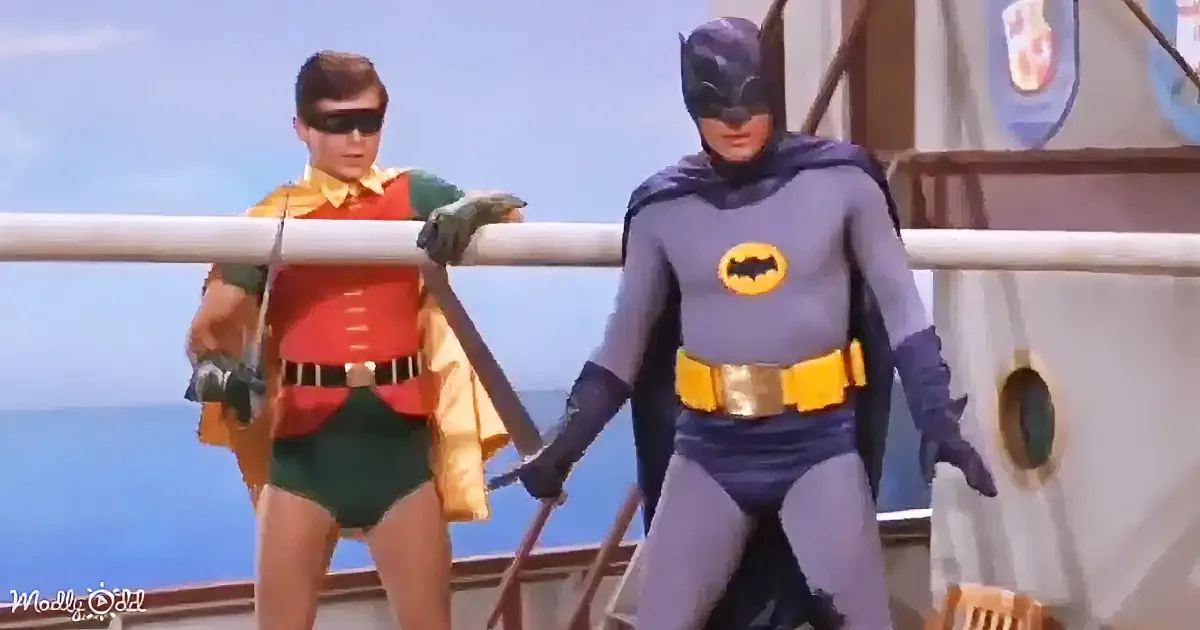 Batman and Robin in their iconic costumes stand on a boat, ready for action.