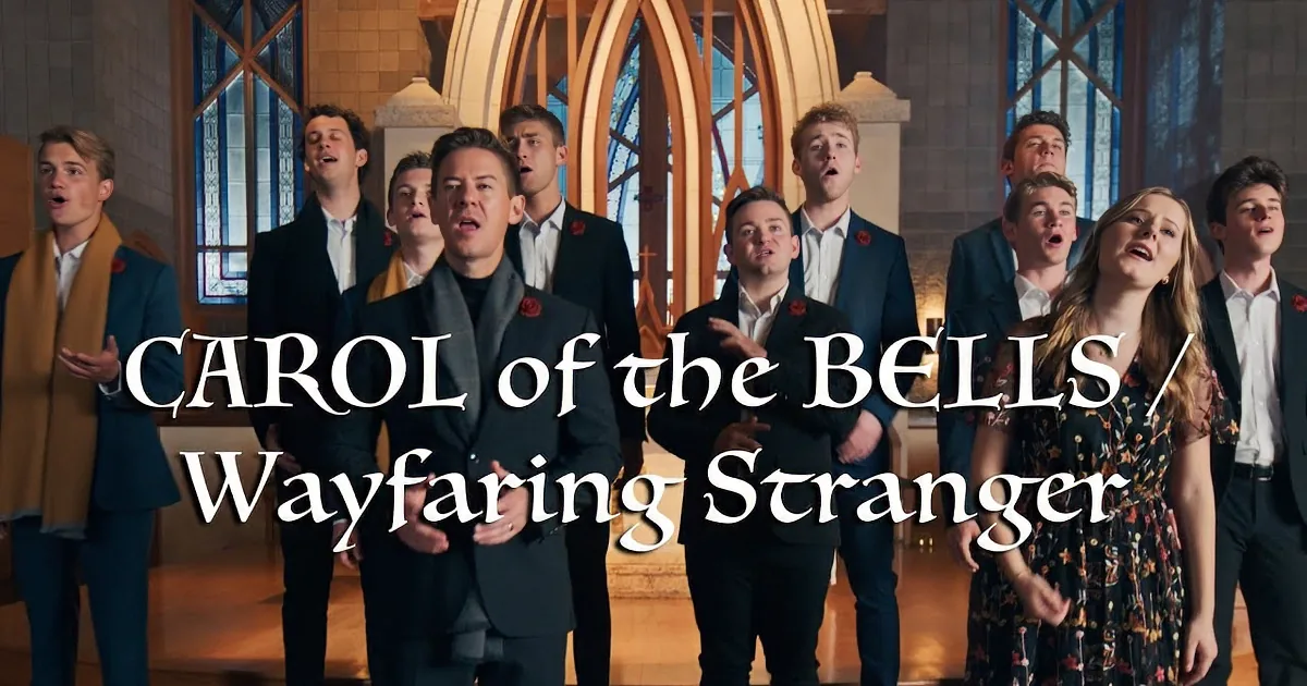 A choir of eight, including a woman in a floral dress, stands on a church stage, singing.