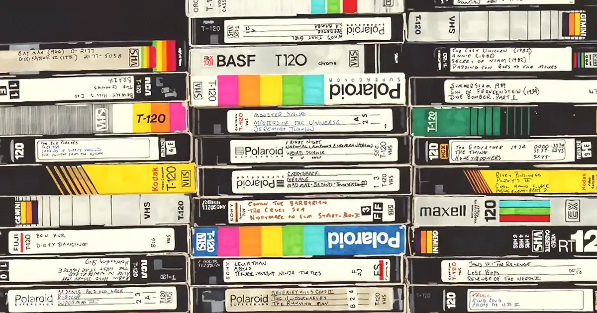 A collection of VHS tapes stacked and labeled with various titles and colors.