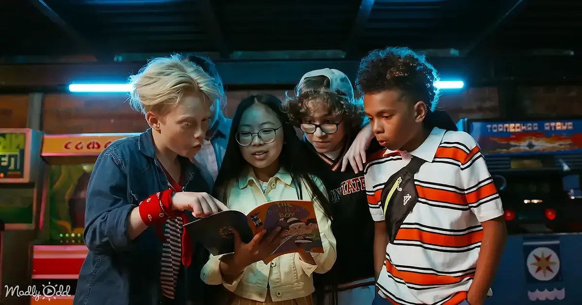 Four friends gather around a book, engrossed in reading, in a neon-lit arcade setting.