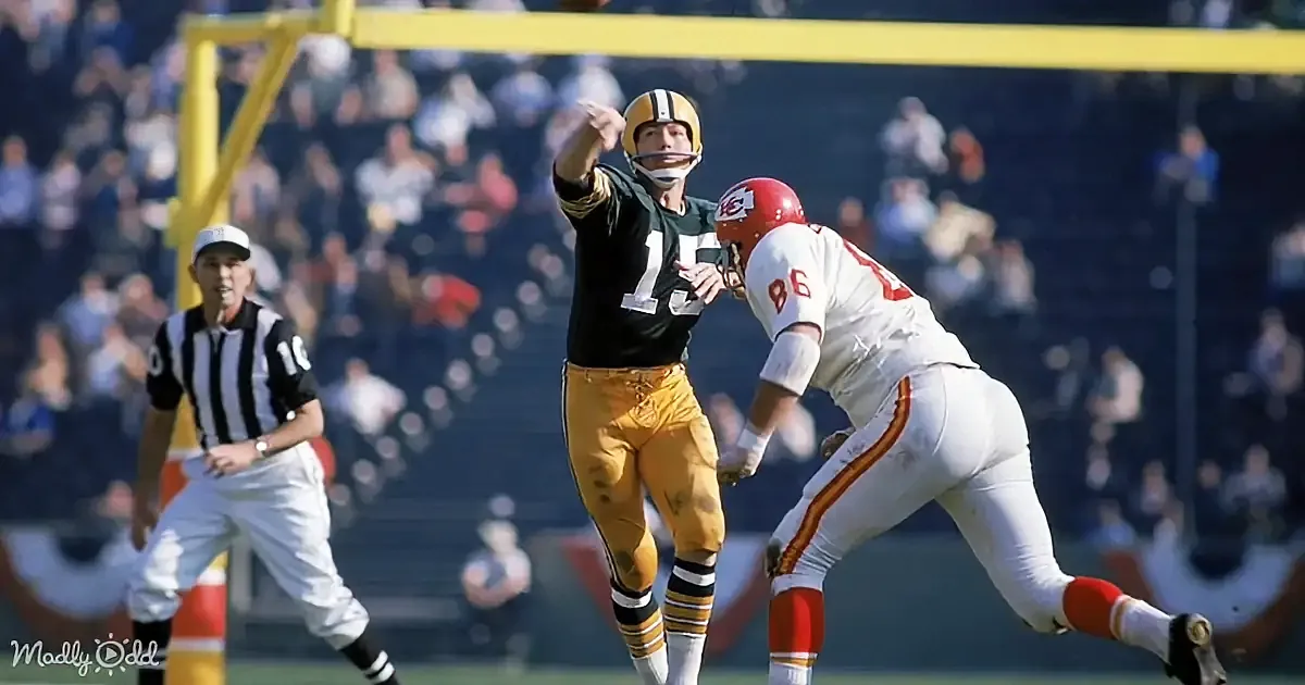A Green Bay Packers kicker prepares to kick the ball during a football game.