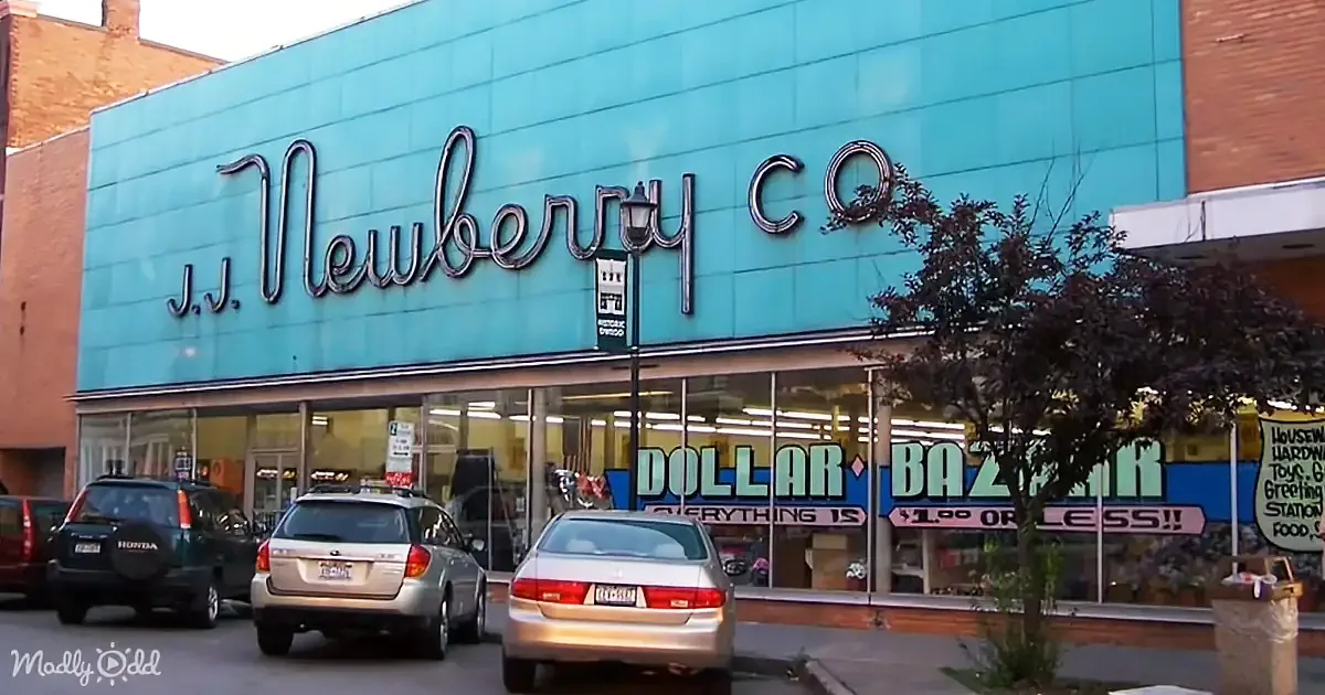 The exterior of the J.J. Newberry Co. store with a blue sign and a "Dollar Bazaar" sign below.