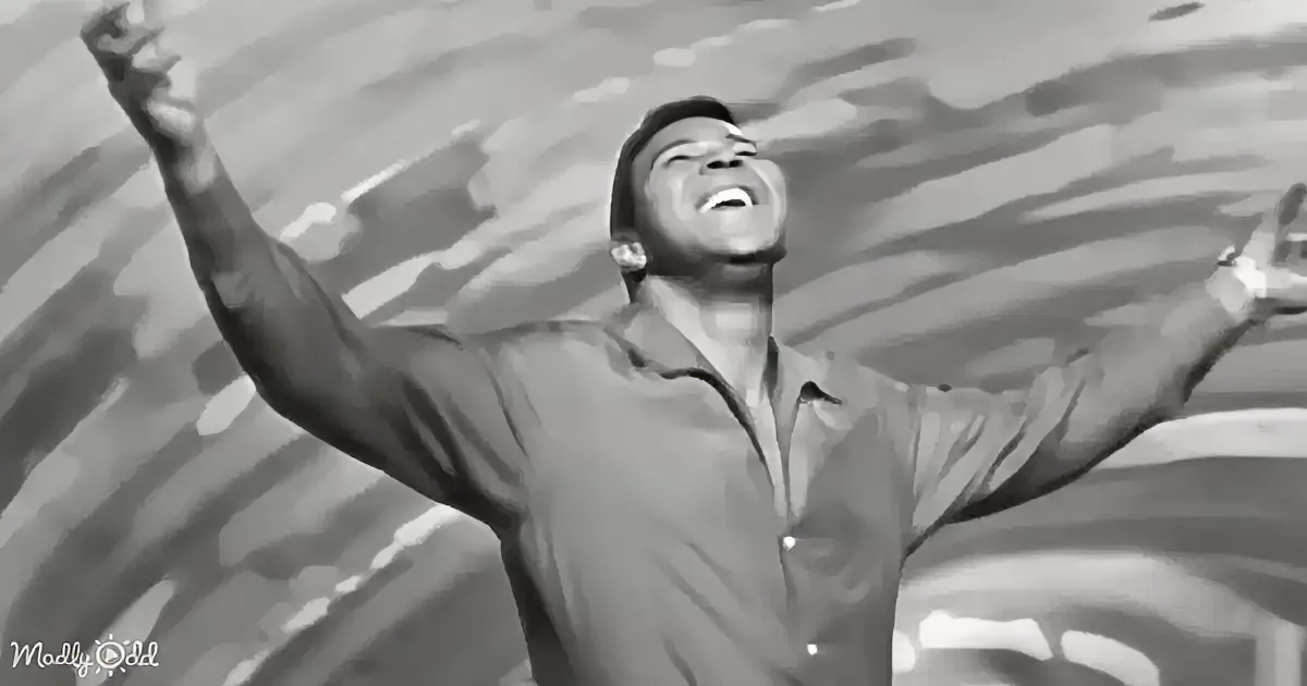 A man in a button-up shirt raises his arms in a joyful gesture against a dynamic, abstract background.