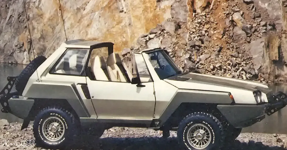 A vintage, boxy, off-road vehicle with large tires and a rugged design is parked near a rocky cliff.