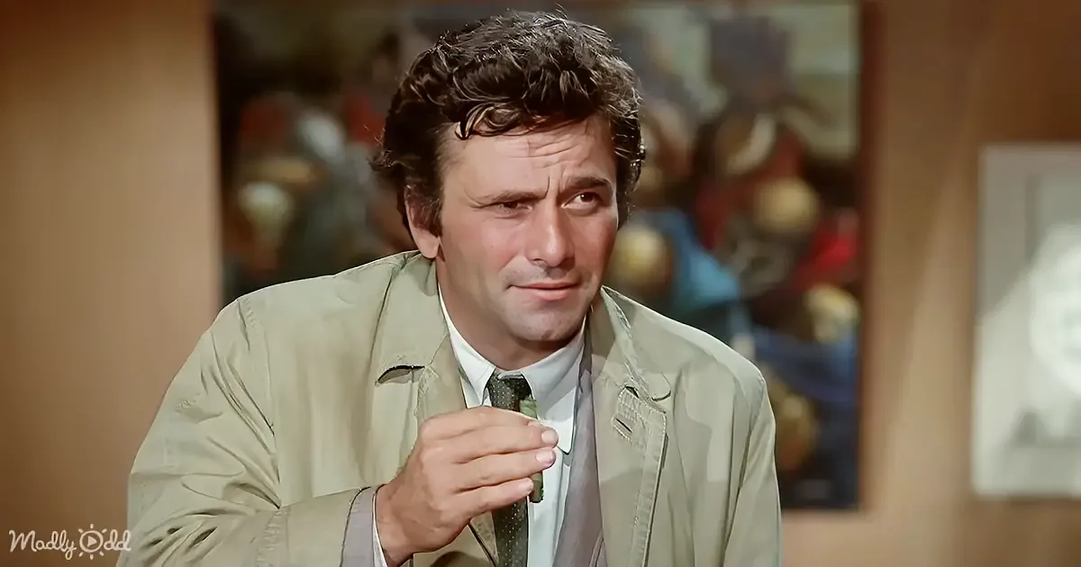 A man in a beige trench coat adjusts his tie, looking to the side with a thoughtful expression.
