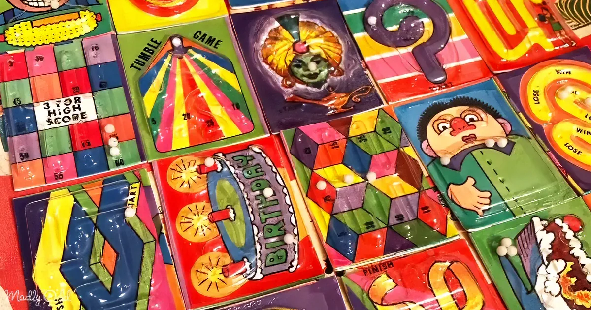 Colorful vintage board games with whimsical designs and playful characters are displayed.