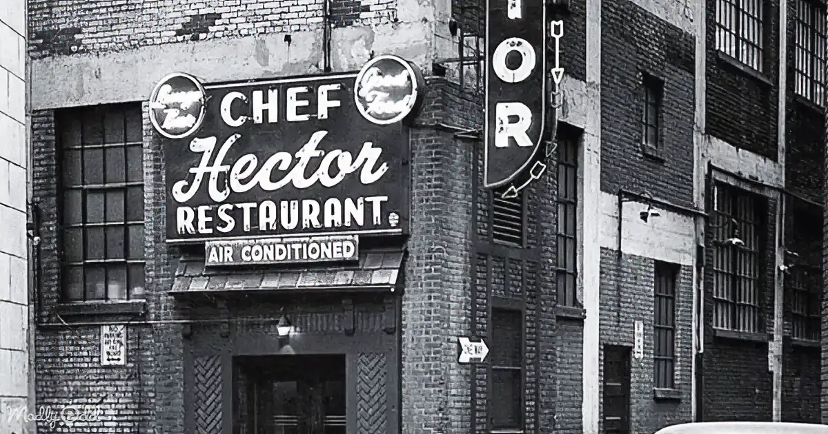 Chef Hector Restaurant sign with "Air Conditioned" below, brick building, vintage style.