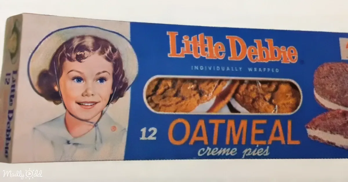 A Little Debbie box of 12 oatmeal cream pies with a smiling girl on the left.