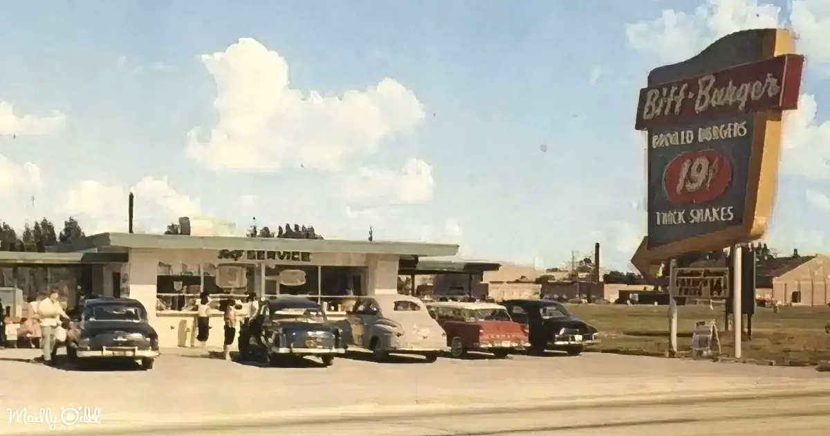 Biff-Burger sign advertises broiled burgers and shakes, with classic cars lined up at the drive-thru.