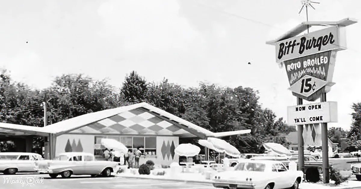 Biff-Burger sign advertises "Roto Broiled" burgers for 15 cents, with a retro diner and cars in the background.