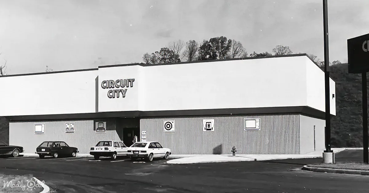 A Circuit City store with a simple facade and parked cars in front.