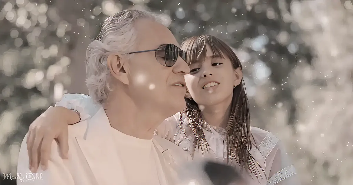 A man and a young girl share a tender moment in a snowy setting.