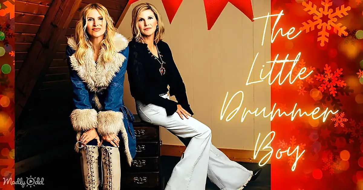 Two women in winter attire pose against a festive background with "The Little Drummer Boy" text.