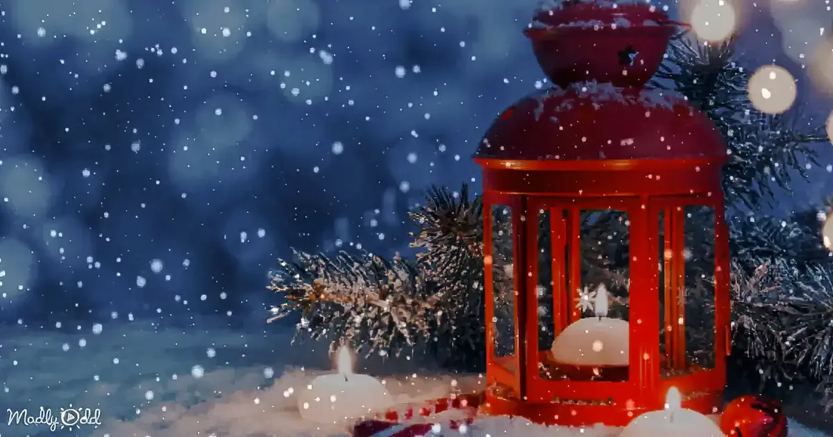 A red lantern with a lit candle inside, surrounded by snowflakes and pine branches.