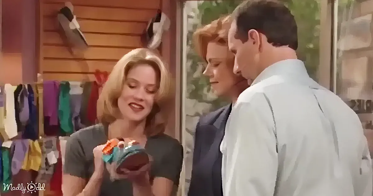 A woman holds a shoe while a man and another woman look on in a store setting.
