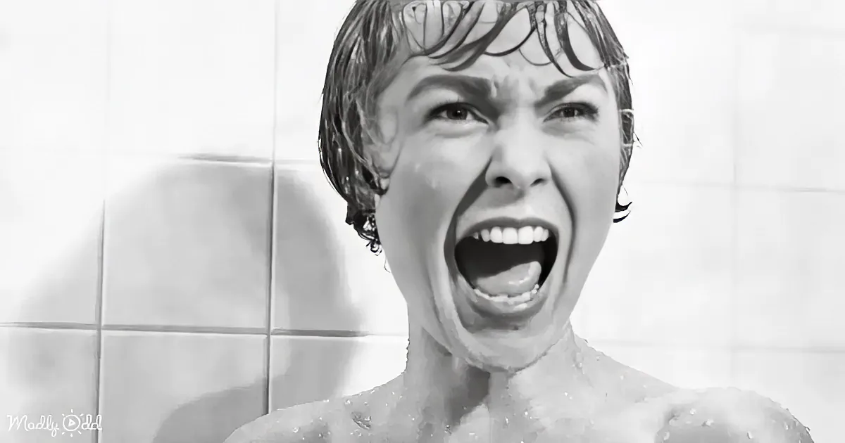A person with wet hair and a distressed expression stands in front of tiled walls.