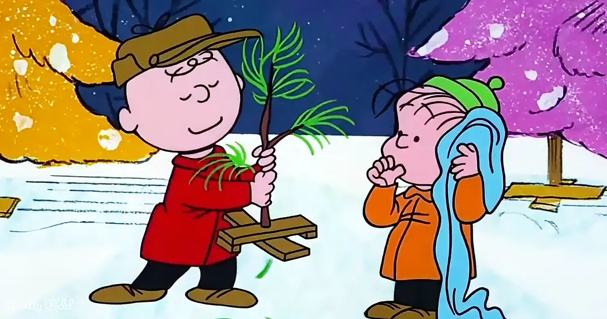 Linus holds a plant while Charlie Brown looks on in a snowy scene.
