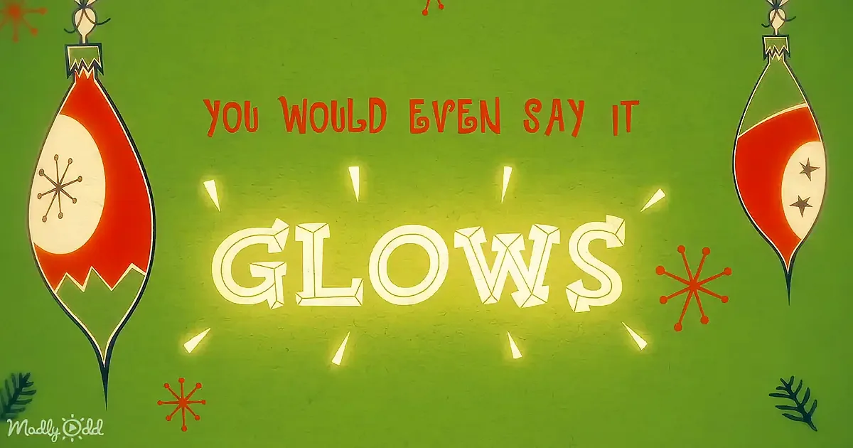 A festive green background with ornaments and the text "YOU WOULD EVEN SAY IT GLOWS" in bold, decorative font.