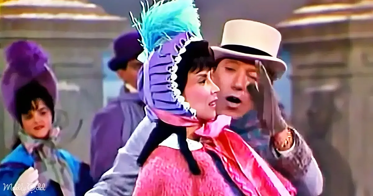 A person in a pink outfit and purple hat with a feather is being embraced by another person in a white hat.