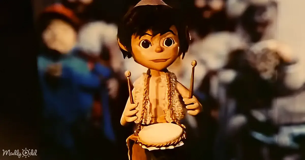 A cartoon character plays a drum with drumsticks, surrounded by a blurred crowd.