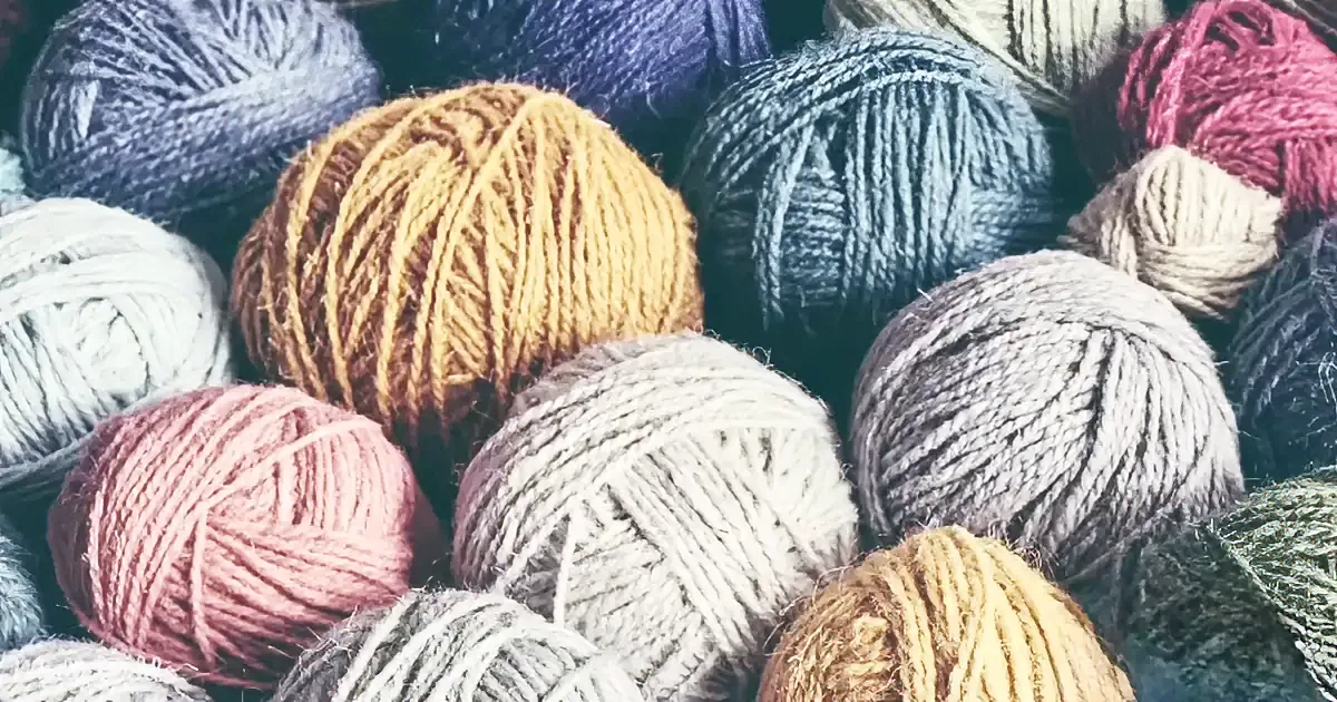 A variety of colorful yarn balls in different shades and textures.