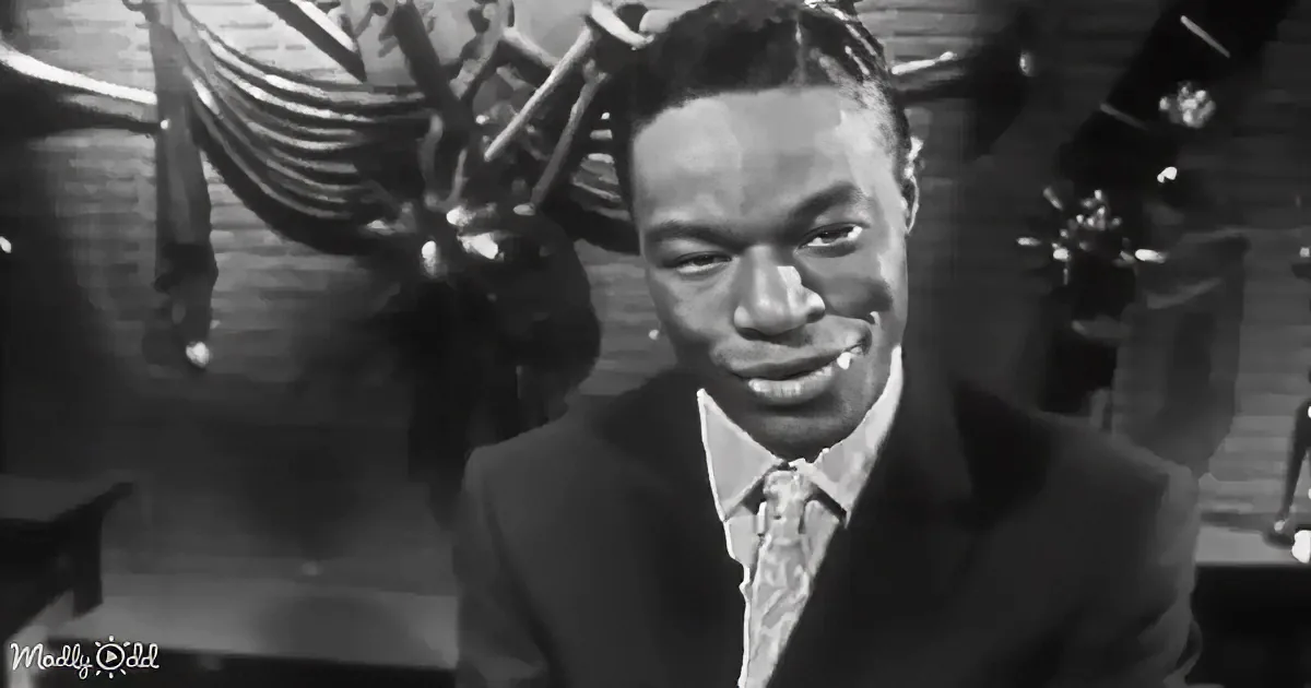 A man in a suit and tie smiles in a black-and-white setting with a decorative background.