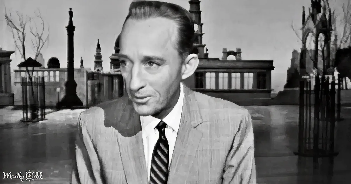 A man in a suit and tie stands in a black-and-white setting with a gothic-style building and trees in the background.