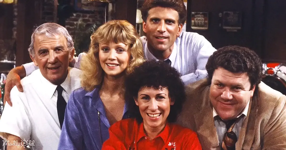 A group of five people posing together in a warm, friendly manner.