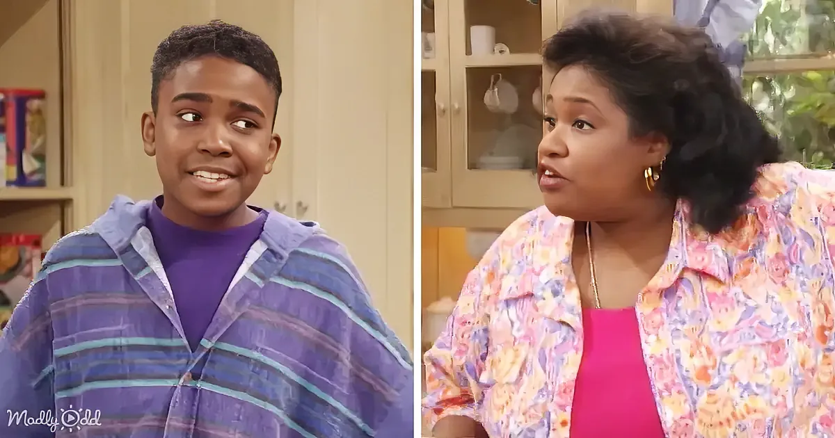 A young boy in a striped hoodie smiles, while a woman in a floral shirt looks concerned in a kitchen setting.