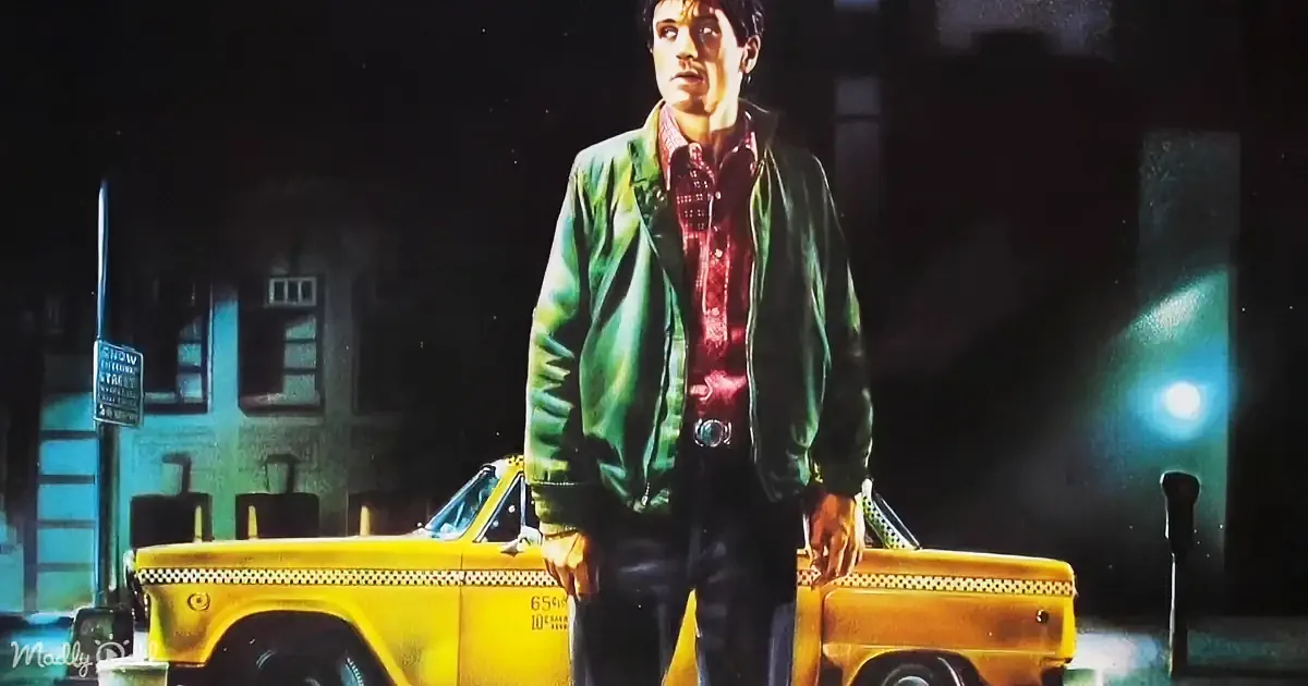 A man in a green jacket stands on a yellow taxi at night, illuminated by a streetlight.