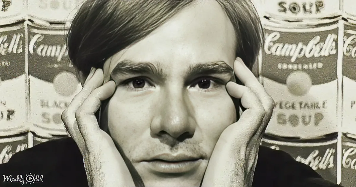 A person with hands on their cheeks, surrounded by Campbell's Soup cans in the background.