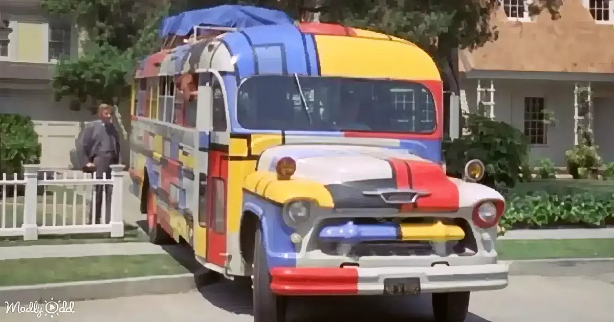A colorful, retro bus with a unique design is parked on a suburban street.