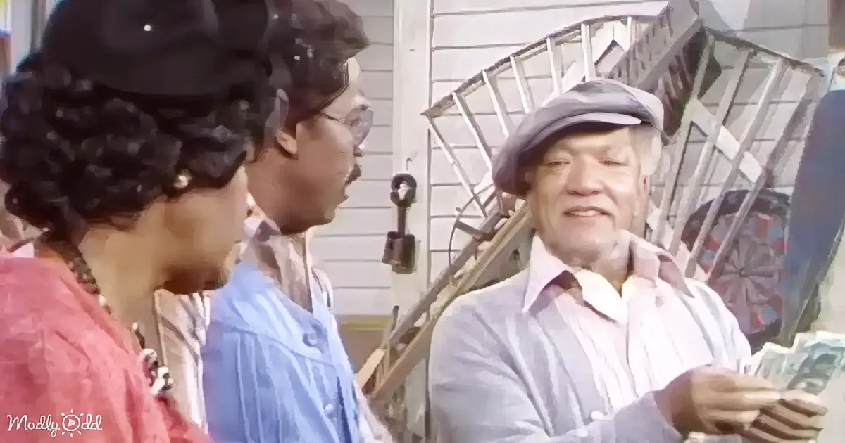 An older man in a cap and pink shirt holds money, standing outside a house with a staircase and a key visible.