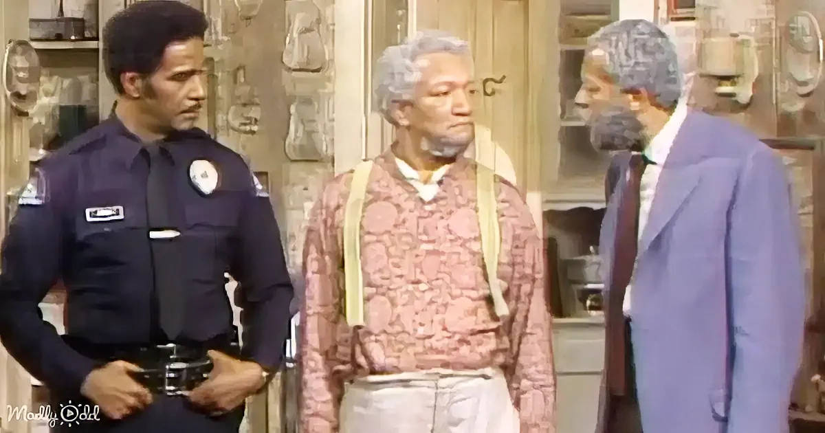 A man in a police uniform stands next to another man in a pink shirt and suspenders, with a third man in a suit nearby.
