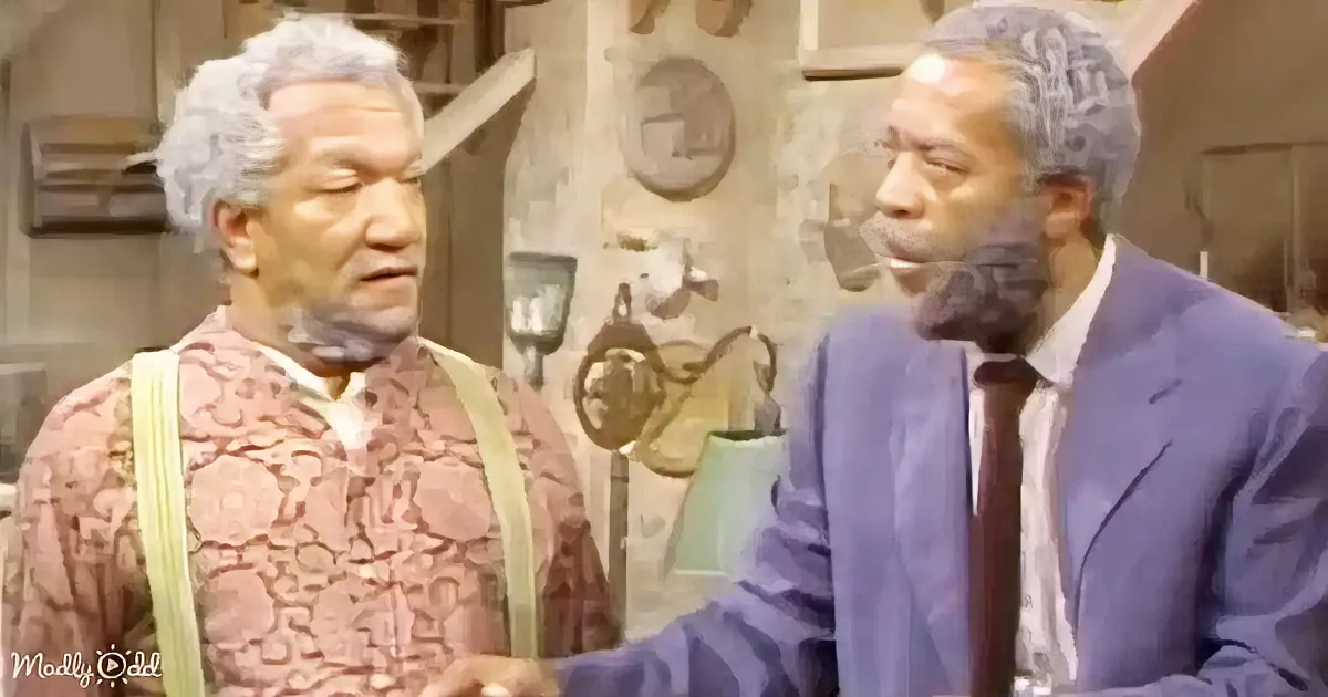 Two men in a rustic setting, one in a patterned shirt, the other in a suit, appear to be having a conversation.