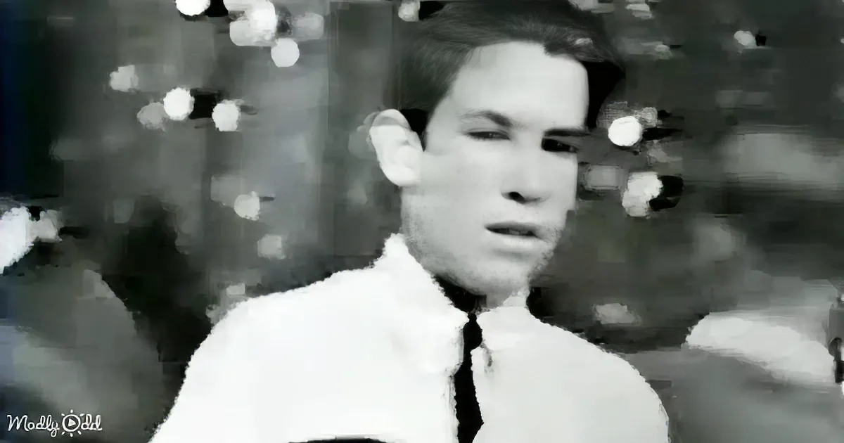 A person in a white shirt with a blurred background and bokeh effect.